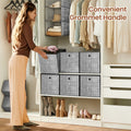Woman putting folded clothes into heathered grey storage cubes in a white wardrobe unit