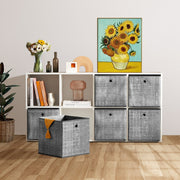 Heathered grey storage cubes filling a white cube shelving unit in a living room