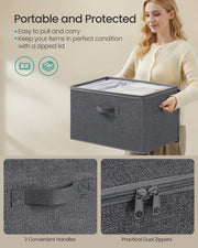Close-up of the box's carry handle and dual zip lid pulls, with a person carrying a box