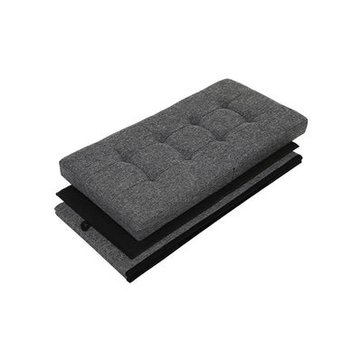 The ottoman folded flat, showing the quilted padded lid and collapsed fabric panels