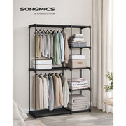 Black wardrobe styled in a bedroom with hanging clothes and folded towels on the shelves
