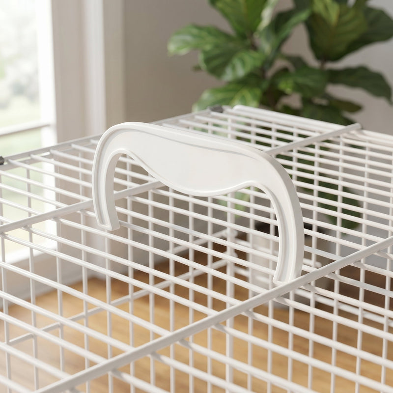 Close-up of the white carry handle and wire mesh roof of the bird cage