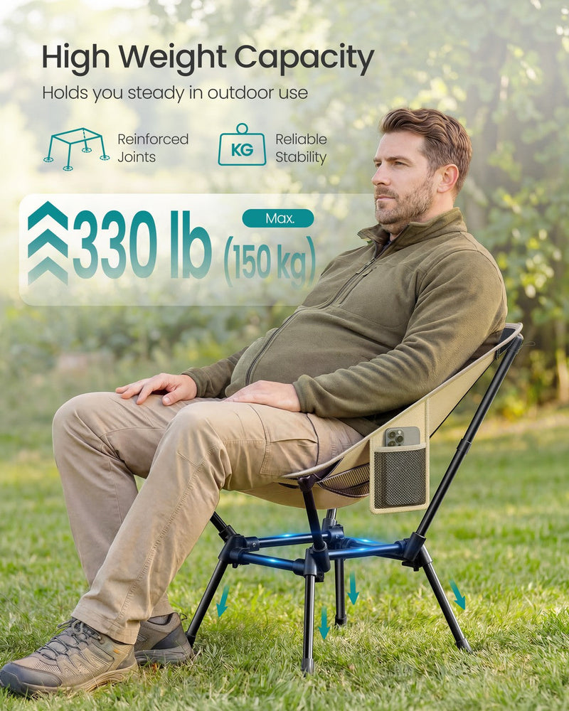 Man seated in the khaki camping chair showing its 150 kg weight capacity