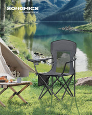 Slate grey Songmics camping chair pitched on grass beside a lake and tent