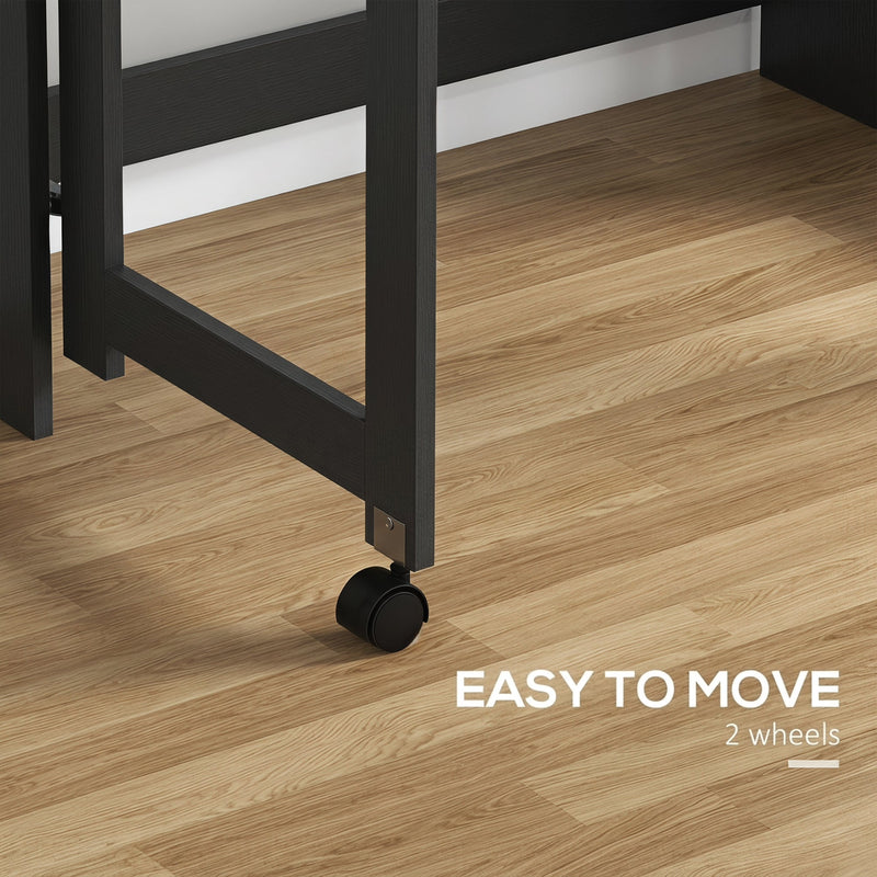 Close-up of one of the two black castor wheels under the desk frame on a wood floor, labelled easy to move with 2 wheels