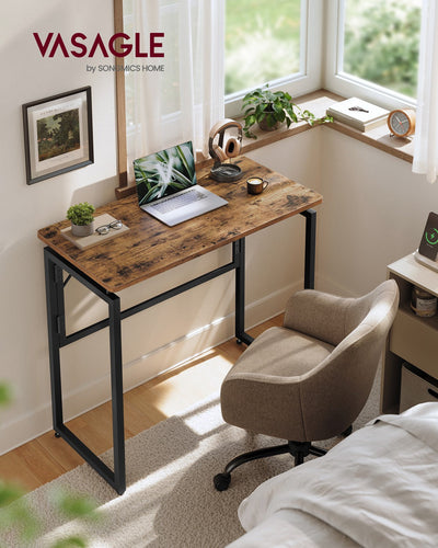 Rustic brown folding desk in a bedroom under a window with a laptop and desk chair
