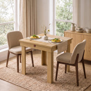 Oak effect folding table folded down for a compact two-person breakfast setting