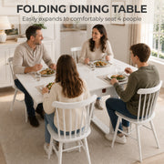 Family of four eating dinner at the extended white folding table