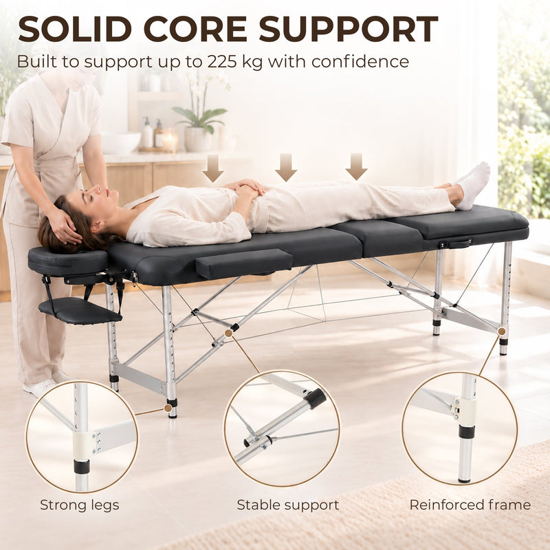 Therapist massaging a client on the table beside a 225 kg support banner
