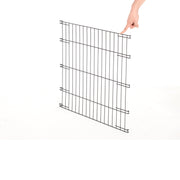 A single metal wire crate panel held up by hand, showing the hinge hooks along its edges