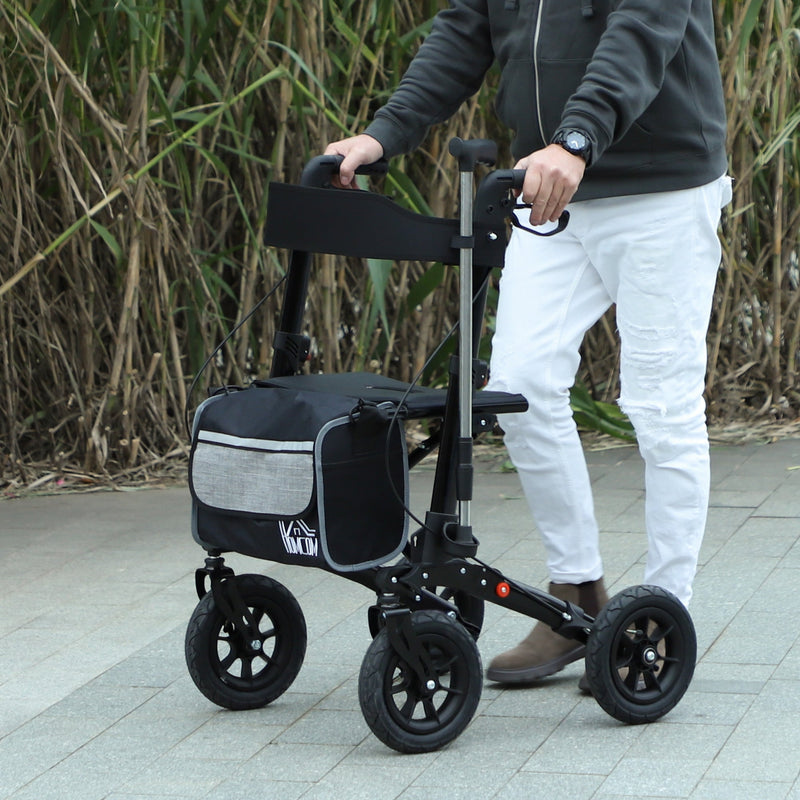 Person walking outdoors using the black rollator walker with storage bag attached
