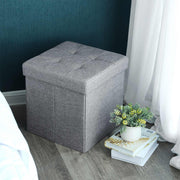 Light grey cube used as a bedside seat against a dark teal wall