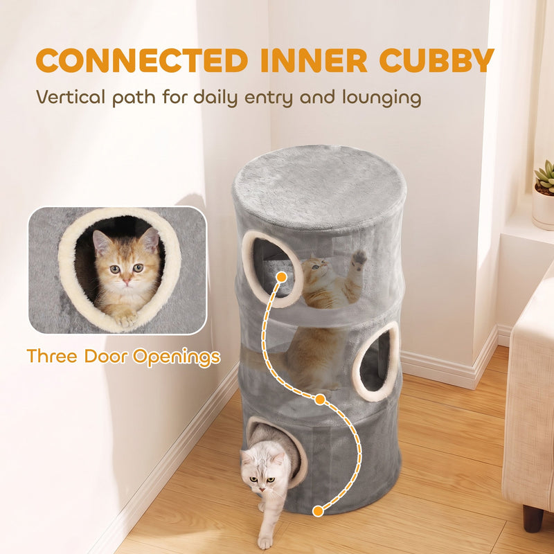 Close-up of a kitten inside a plush-lined door opening, showing the connected path between tower levels
