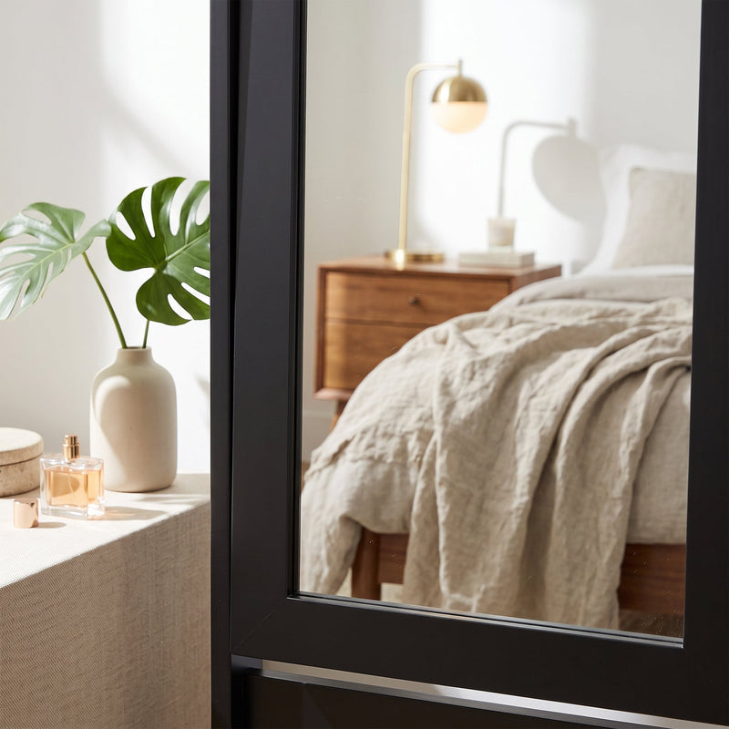 Close-up of the mirror frame corner beside a bedside table
