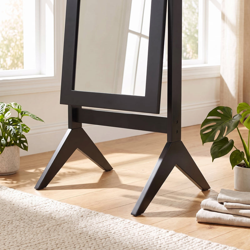 Close-up of the mirror's splayed four-leg base and floor stand
