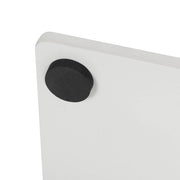 Close-up of the black felt pad on the corner of the white marble base