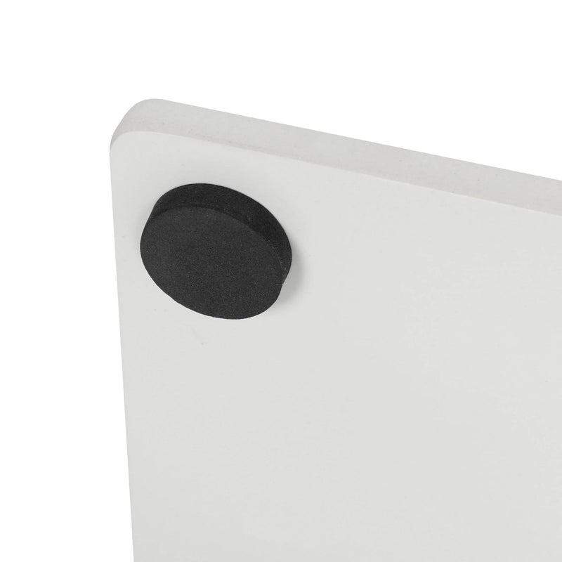 Close-up of the black felt pad on the corner of the white marble base
