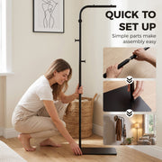 Woman fitting the base of the black clothes rail with three assembly steps shown