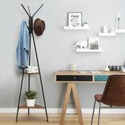 Coat rack stand beside a desk with a denim jacket and brown hat on its hooks