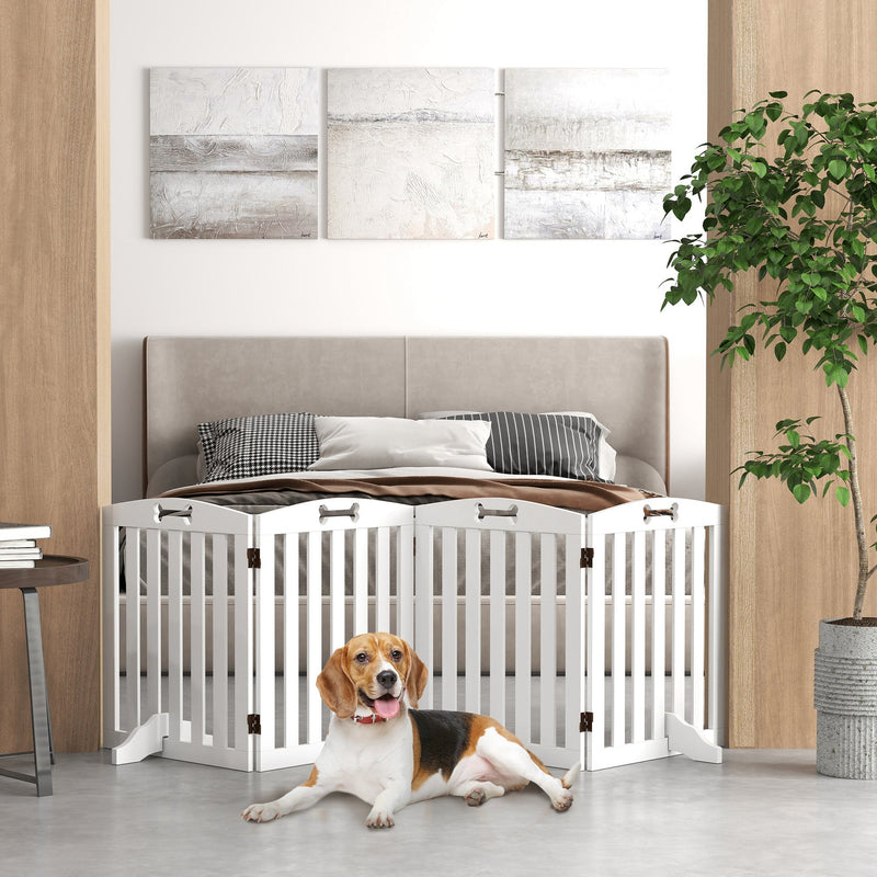 White wooden dog gate set up at the foot of a bed with a dog resting behind it