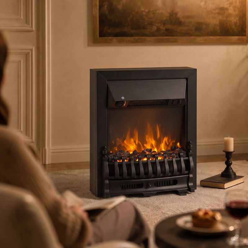 Black coal bed electric fireplace with glowing flames in a living room beside a candle
