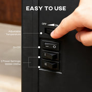 Hand turning the side thermostat dial above the on/off and two power setting switches