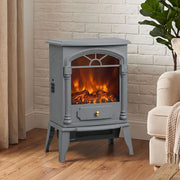Electric stove fireplace standing against a painted brick wall beside an armchair