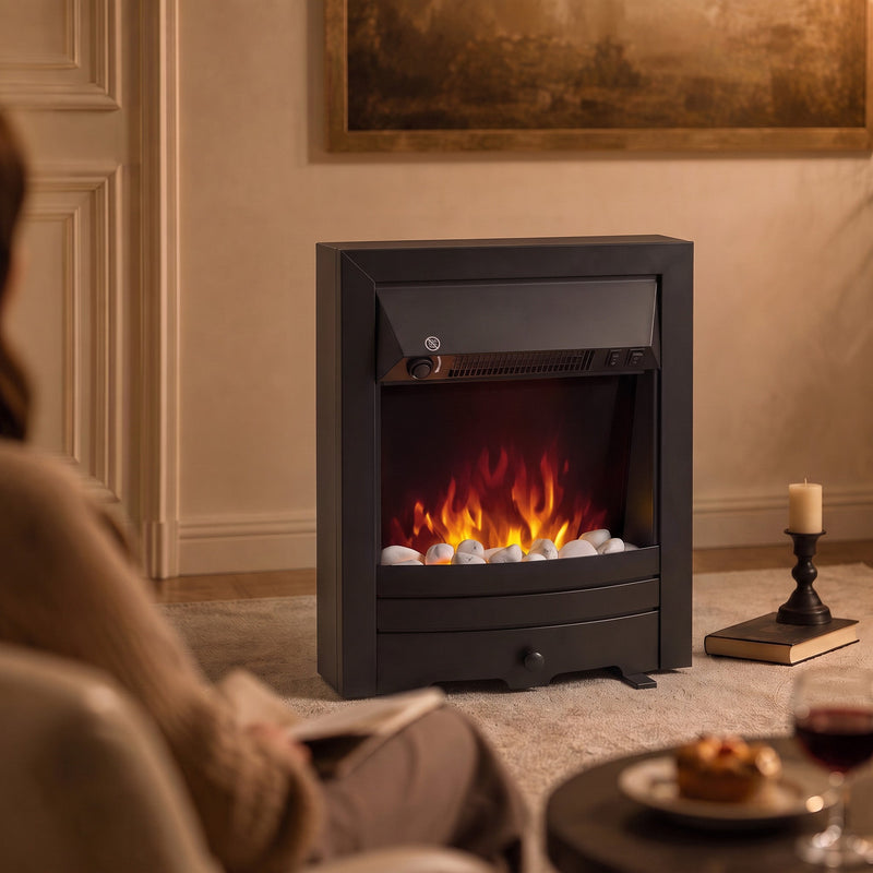 Fireplace with lit flames in a panelled living room beside a candle and a slice of cake