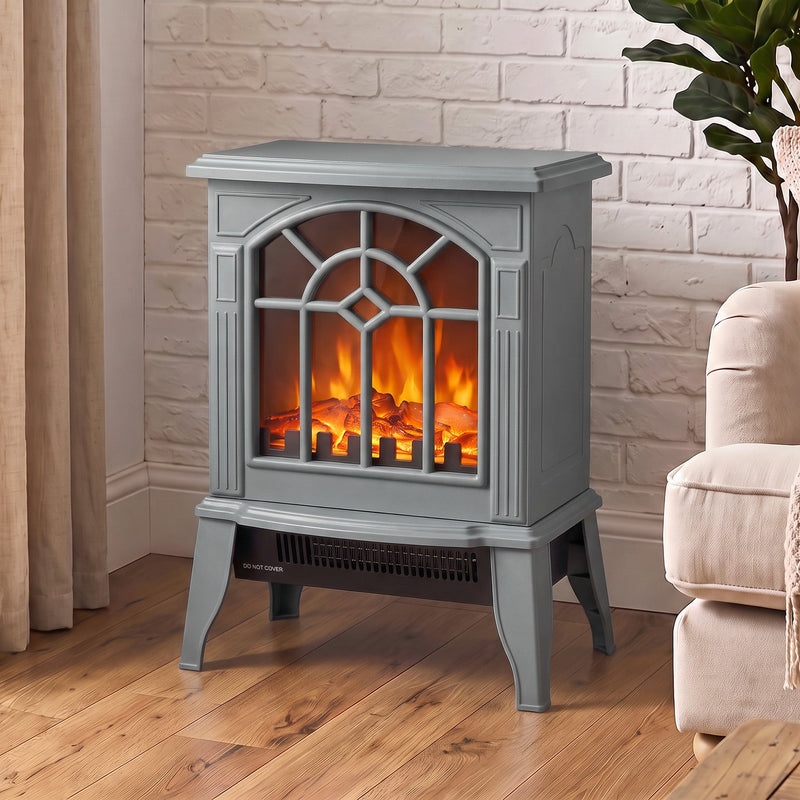 Grey electric fireplace stove glowing against a white brick wall in a modern living room