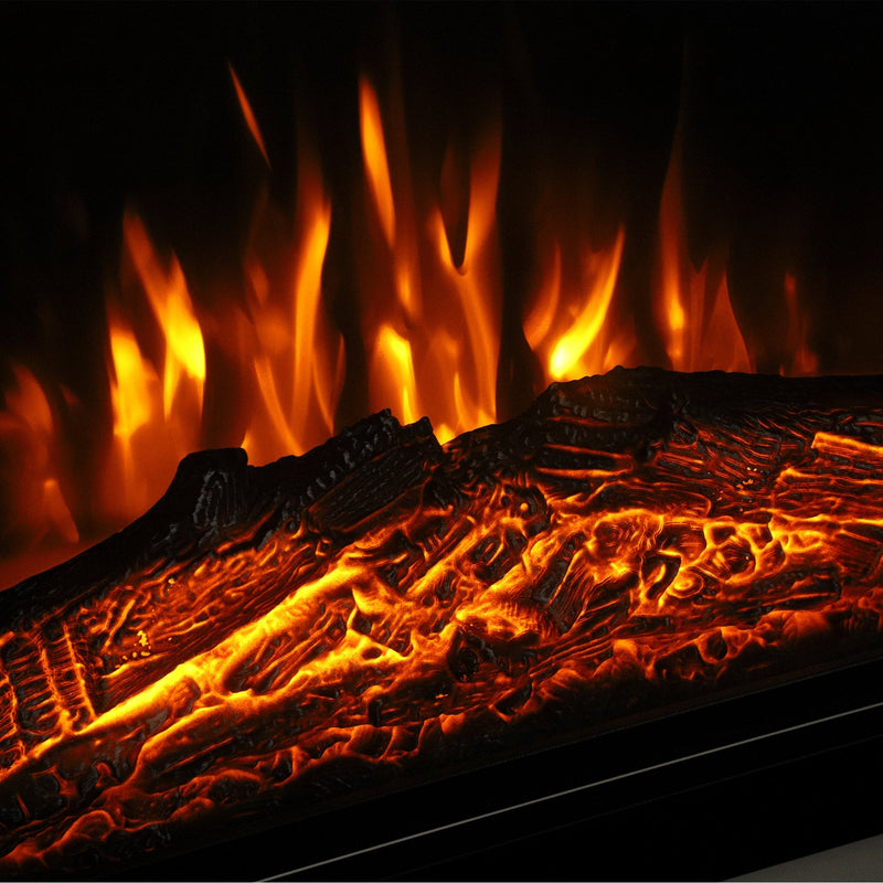 Close-up of orange flames glowing over faux logs