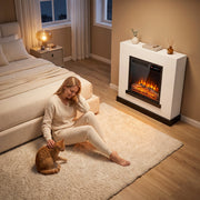 White fireplace suite in a bedroom with a woman and a cat on the rug