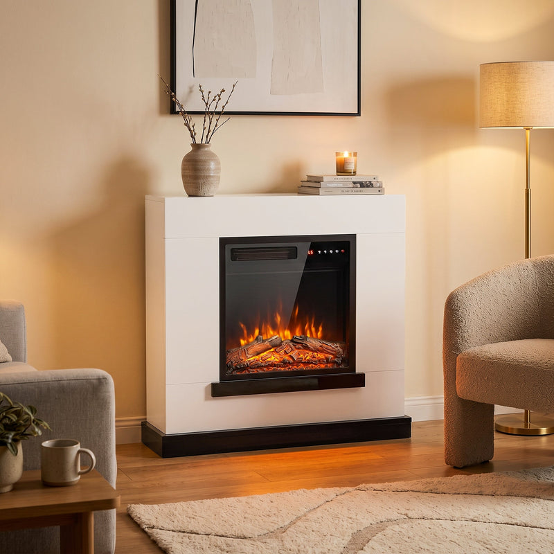 White fireplace suite in a living room beside an armchair and floor lamp
