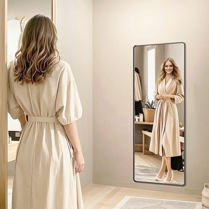 Ink Black full length mirror with stand reflecting a woman in a robe in a bedroom