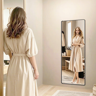 Ink Black full length mirror with stand reflecting a woman in a robe in a bedroom