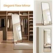 Full length mirror with stand leaning against the wall in a walk-in wardrobe