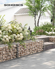 Stone-filled gabion baskets forming a low planted border beside a paved patio