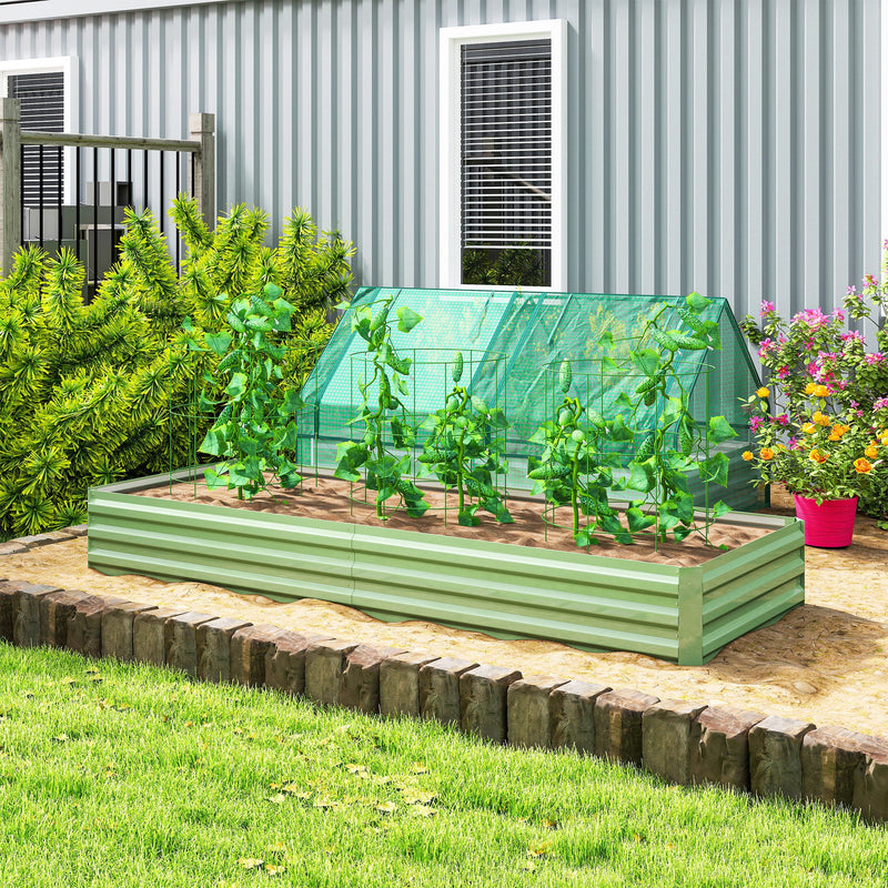 Light green raised garden bed with a plant cover and tomato plants on a lawn