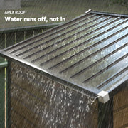 Close-up of rain running off the ridged apex roof and down the shed's side panels