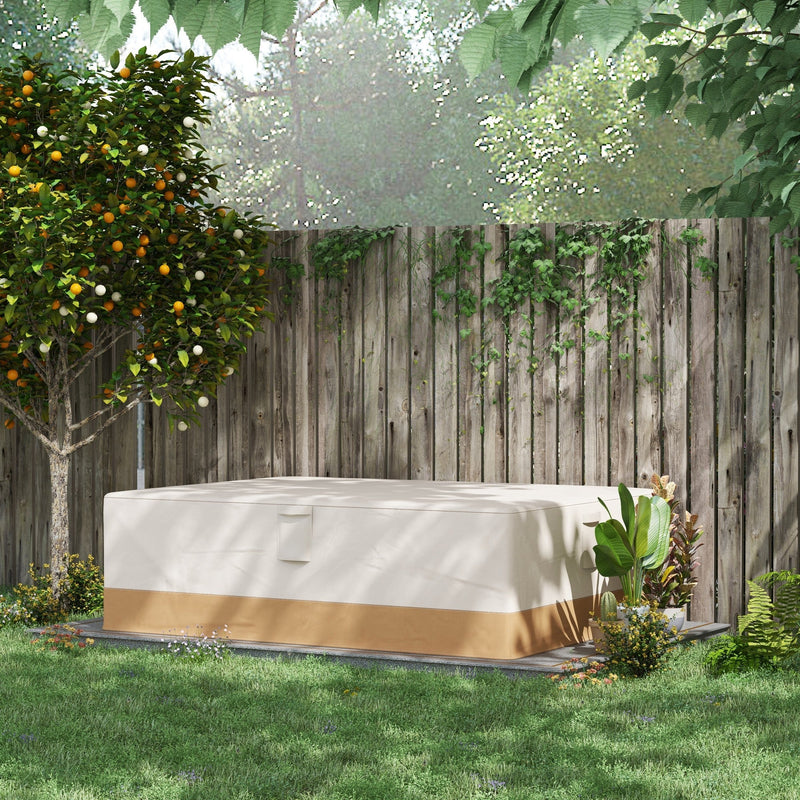 Beige furniture cover over a garden set on a lawn in front of a wooden fence