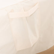 Close-up of a buckle strap tab on the beige furniture cover