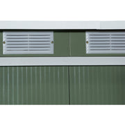 Close-up of two louvred vents set into the green wall panel
