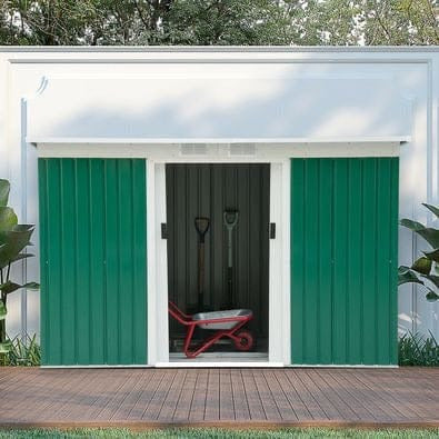 Green 9x4ft metal garden shed with sliding doors open beside a white fence
