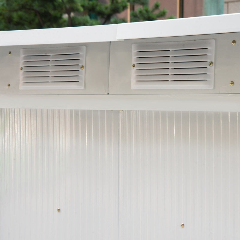 Close-up of two louvred vents above a cream corrugated wall panel