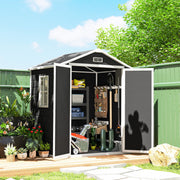 Black resin garden shed in a garden with both doors open showing tools and shelving