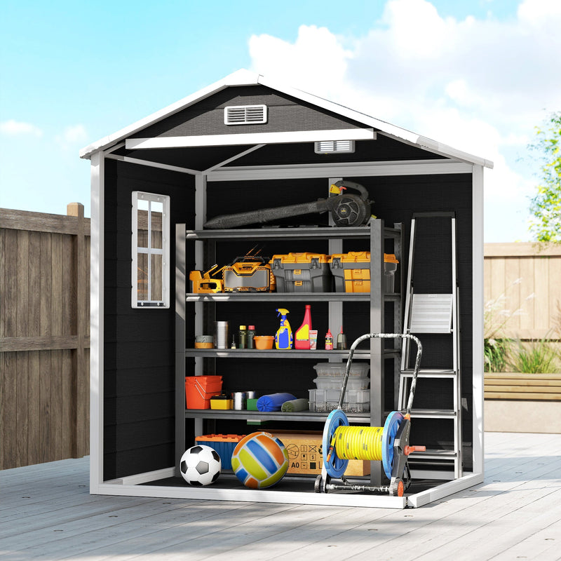 Cutaway view of the black plastic shed holding tools, balls, a hose reel and a ladder