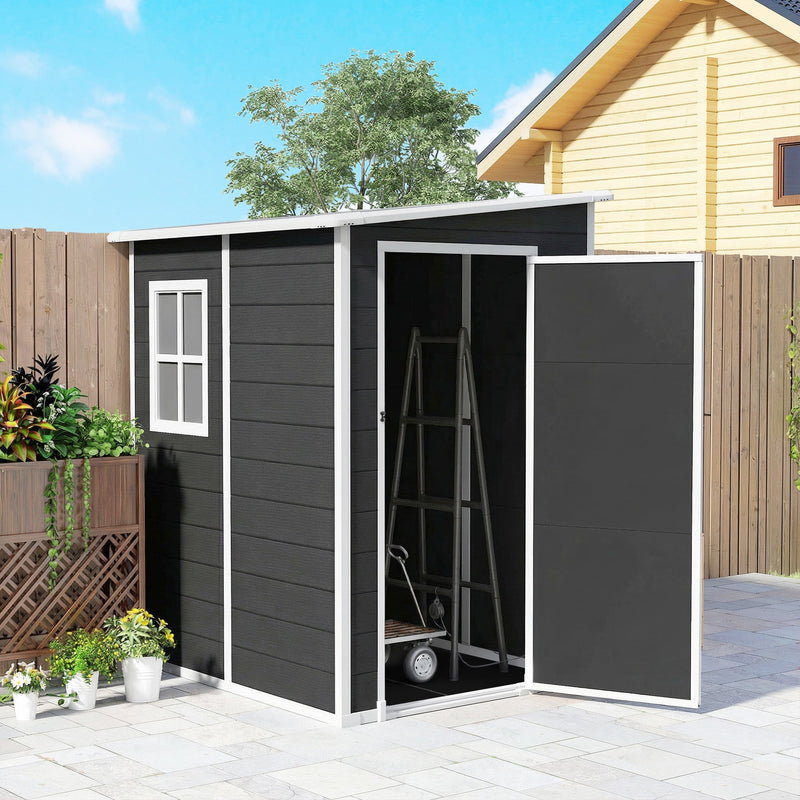 Black lean to shed beside a fence with the door swung open and a step ladder stored inside