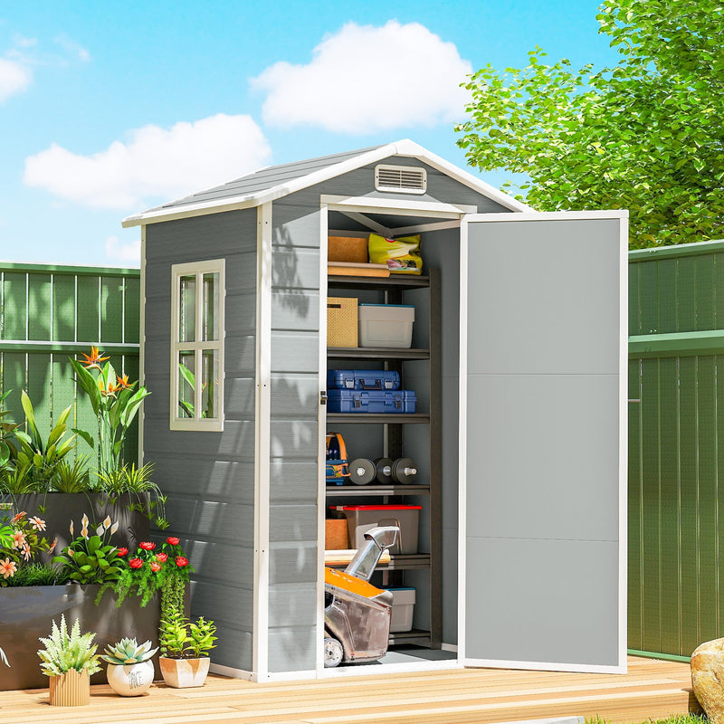 Outsunny 4x3ft plastic shed on a patio deck with the door open, shelves holding boxes and tools
