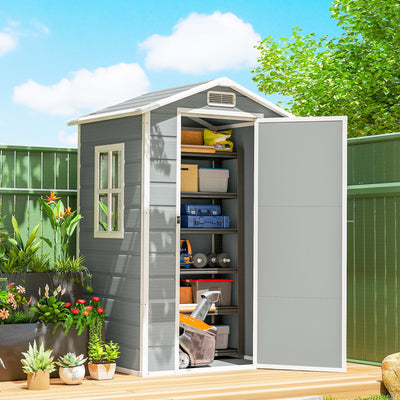 Outsunny 4x3ft plastic shed on a patio deck with the door open, shelves holding boxes and tools