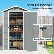 Shed door open showing the 62.5 cm wide by 165 cm high opening, with padlock and keys inset