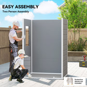Two people assembling the grey plastic shed panels outdoors, with protective gloves and a drill